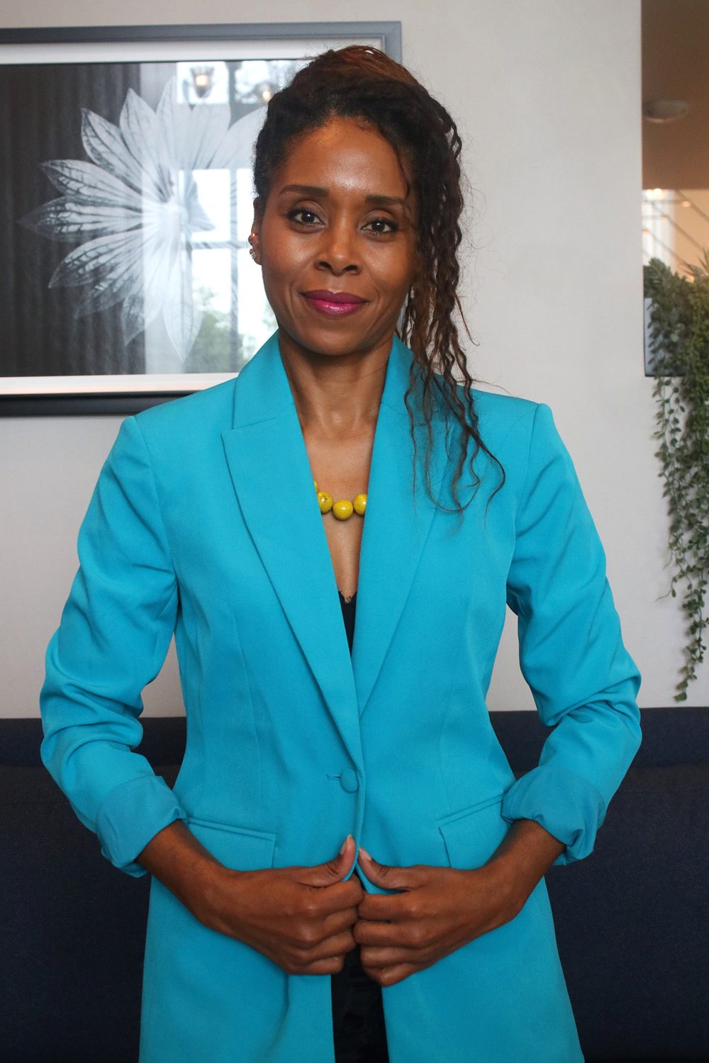 Executive Edge client in a teal blazer photographed at a Venture to Bloom studio session